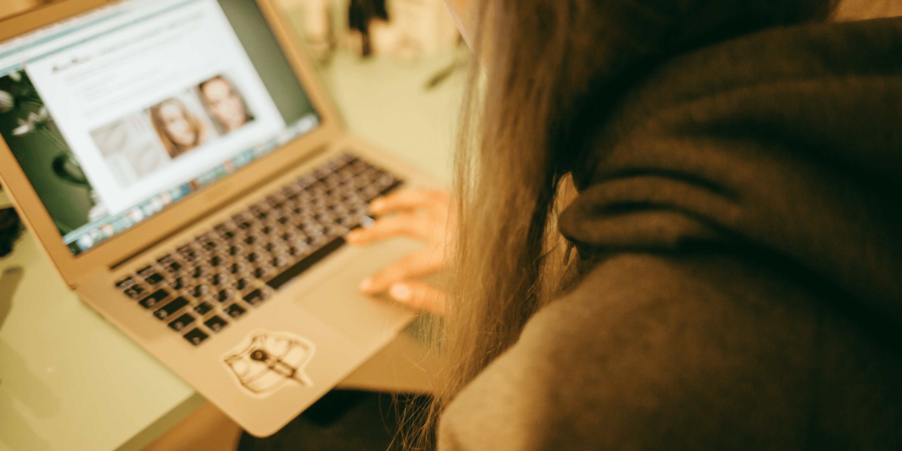 Young person looking at information on a laptop